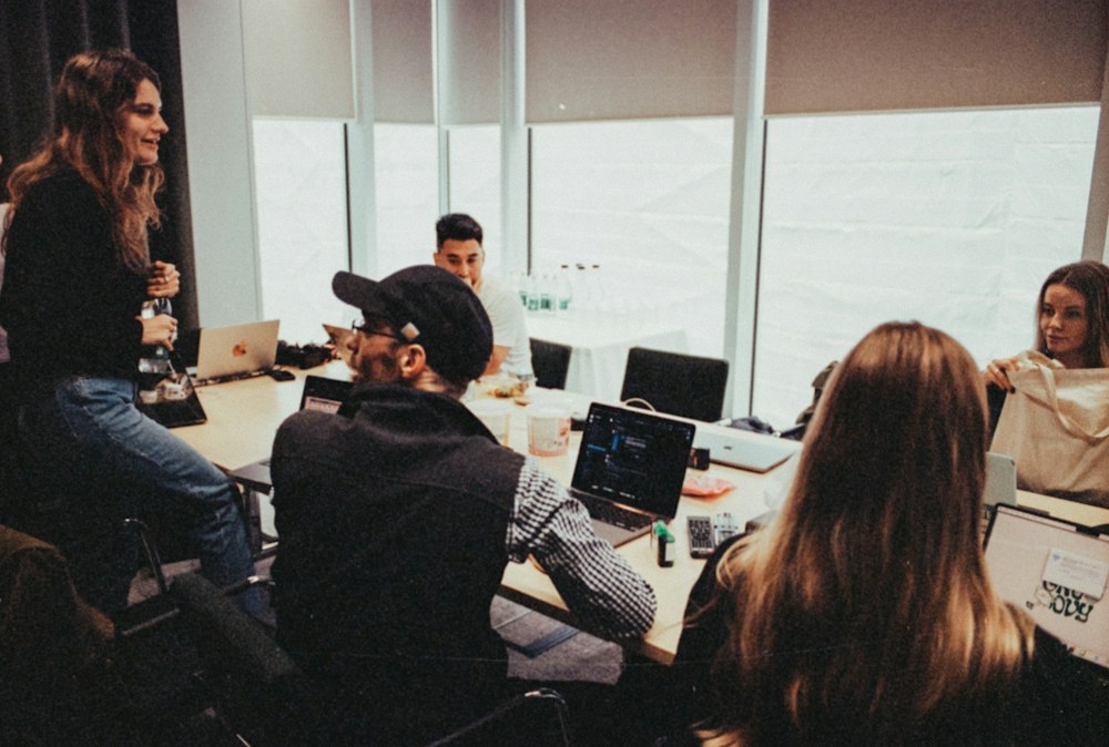Business team collaborating around a table with laptops